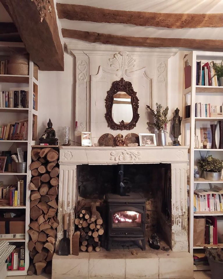 Rustic French country interior with fireplace and bookshelves - @lafermederce. #frenchcountry #rusticrefined #oldworldstyle #frenchfireplace #frenchfarmhouse #interiordesign