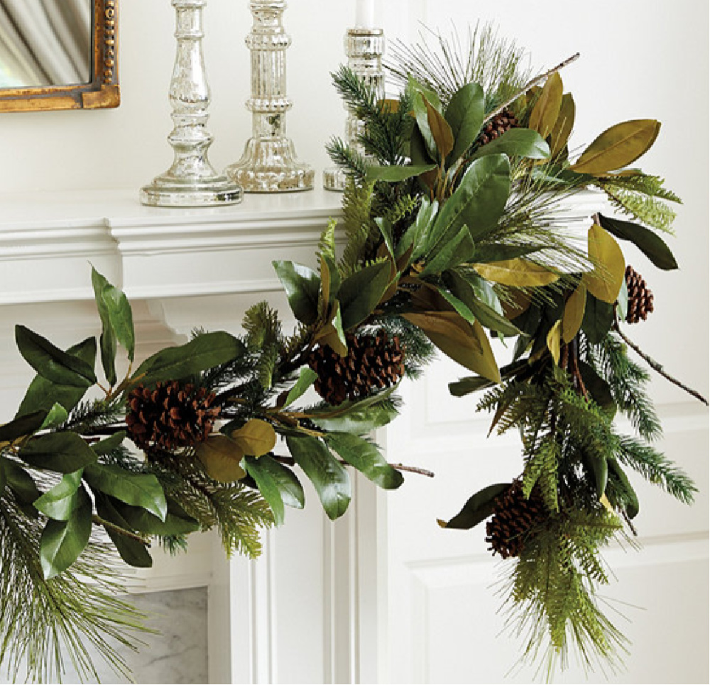 Faux evergreen garland with magnolia and pinecones - Ballard Designs. #holidaydecor #garlands