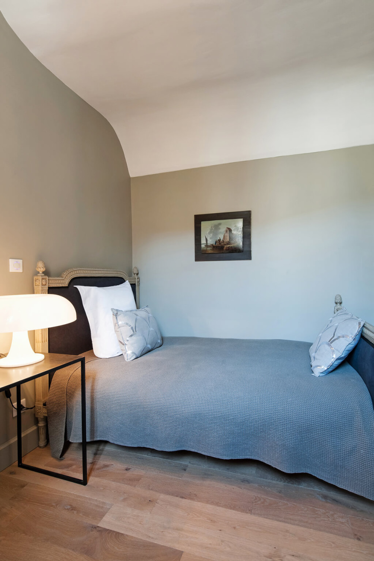 Modern French bedroom with wide plank wood floor in Avignon Hôtel Particulier, a beautifully restored 19th century mansion in the heart of Avignon’s historic center - Haven In. #modernfrench #bedroomdecor #frenchchateau #provence #frenchcountry #restoredchateau #southoffrance #aivgnonhotel