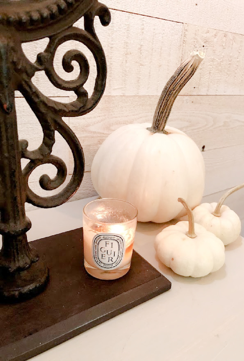 White pumpkins and Diptyque Figuier candle in my fall bedroom - Hello Lovely.