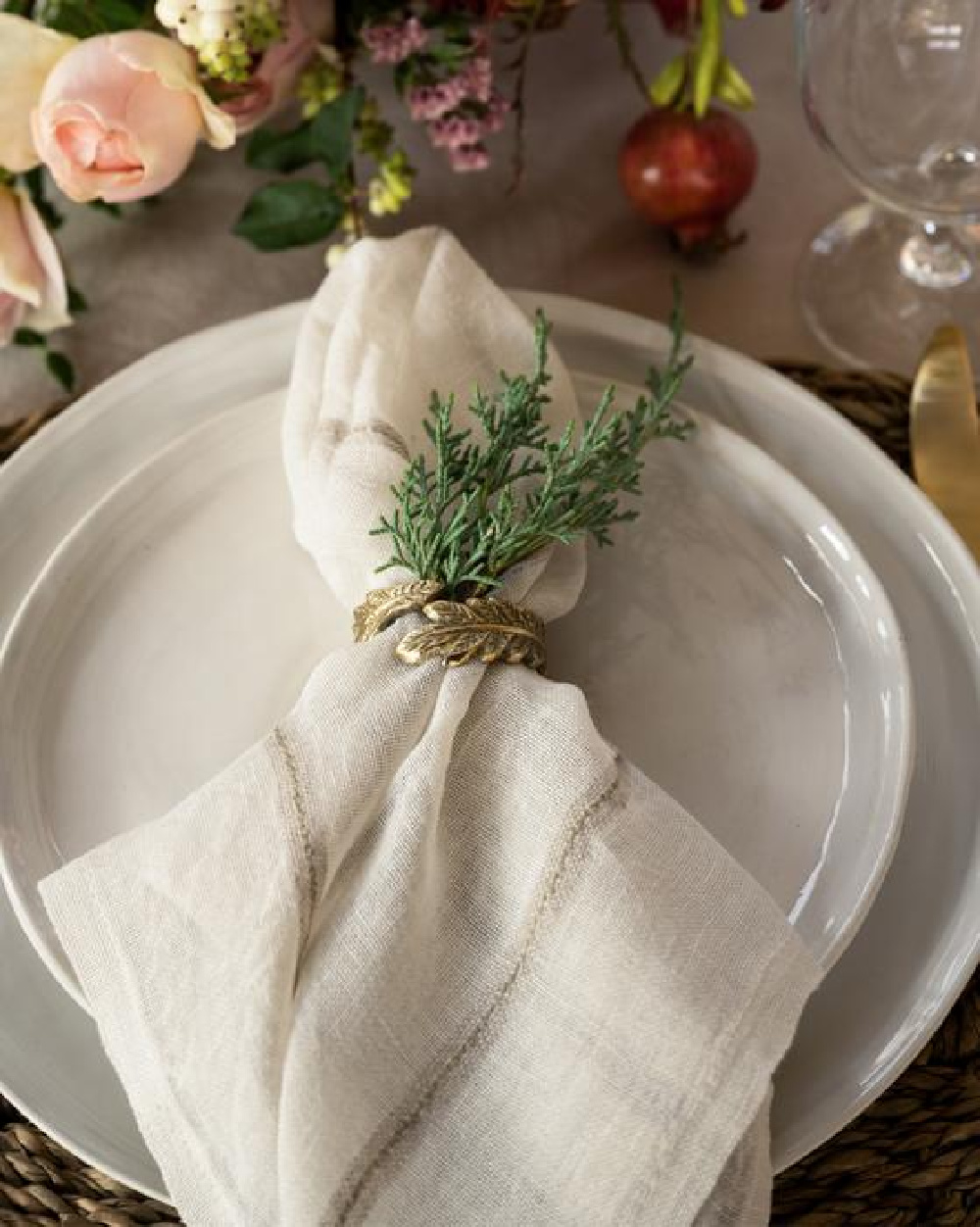 Simple and natural Christmas holiday placesetting with brass napkin ring, fresh greenery, and cloth napkin - McGee & Co. #holidaytable