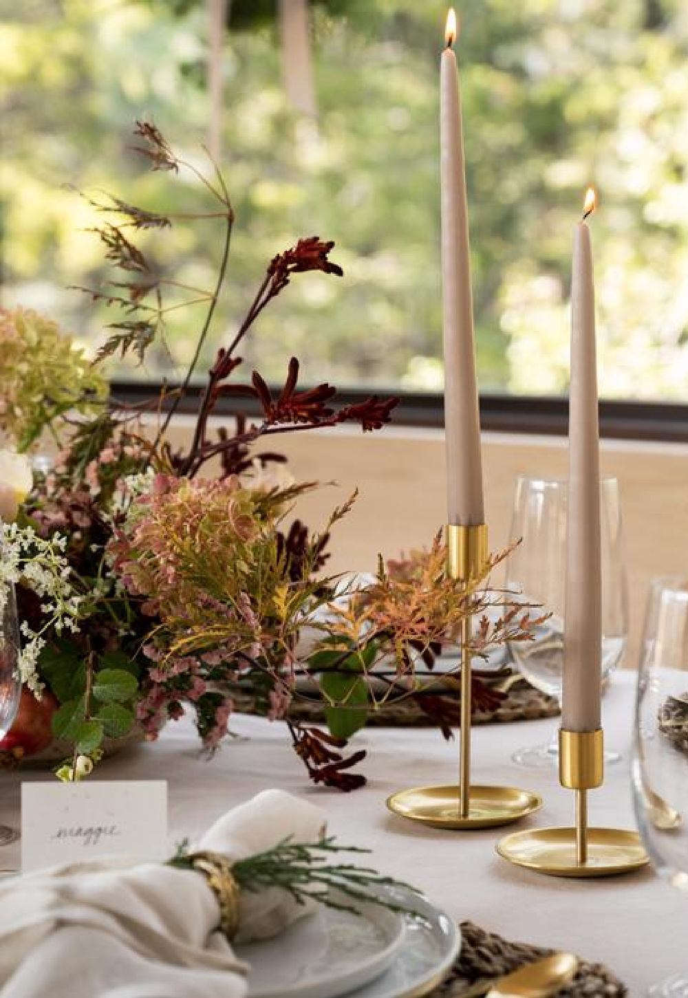 Brass candle holders and sandstone candles on a lovely neutral and natural holiday table by McGee & Co.