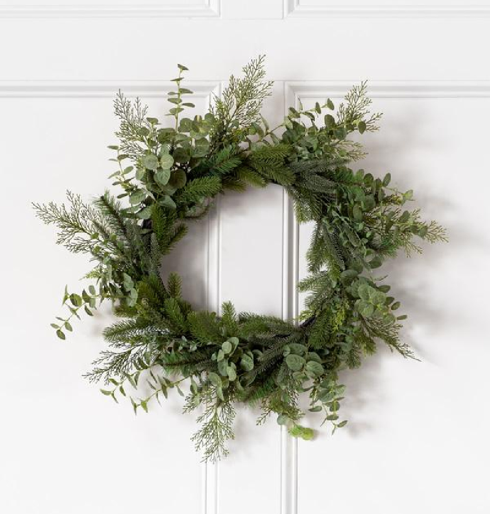 Evergreen faux wreath on a white door - McGee & Co.