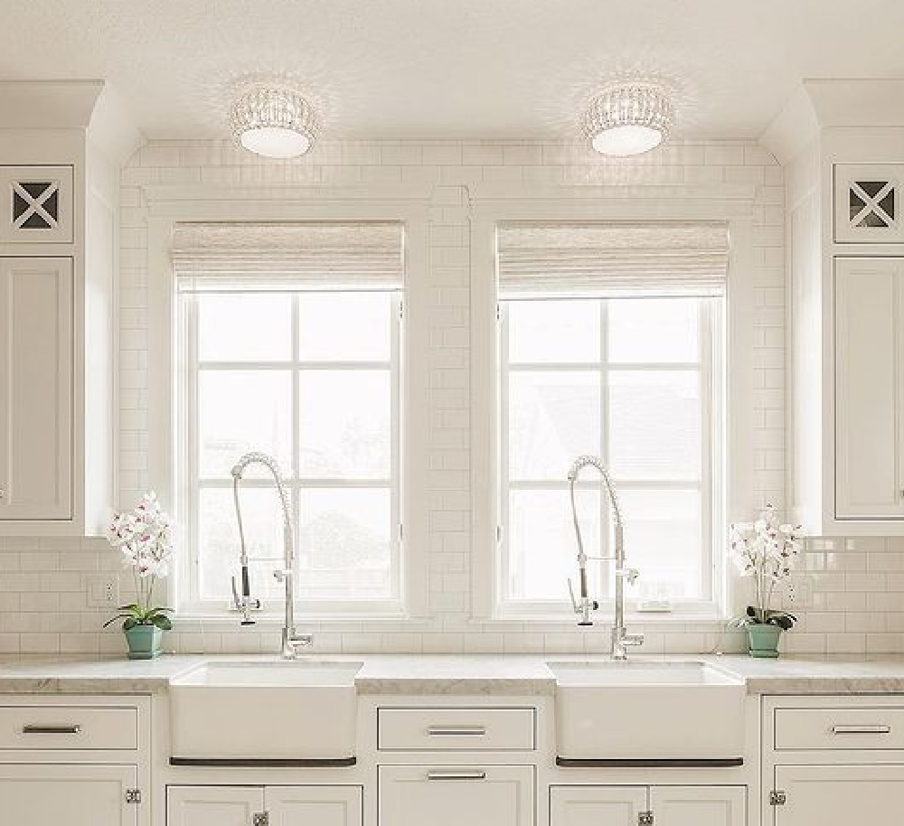 Double farm sinks in a white kitchen with subway tile and Shaker style -The Fox Group. #dualsinks #bespokekitchens