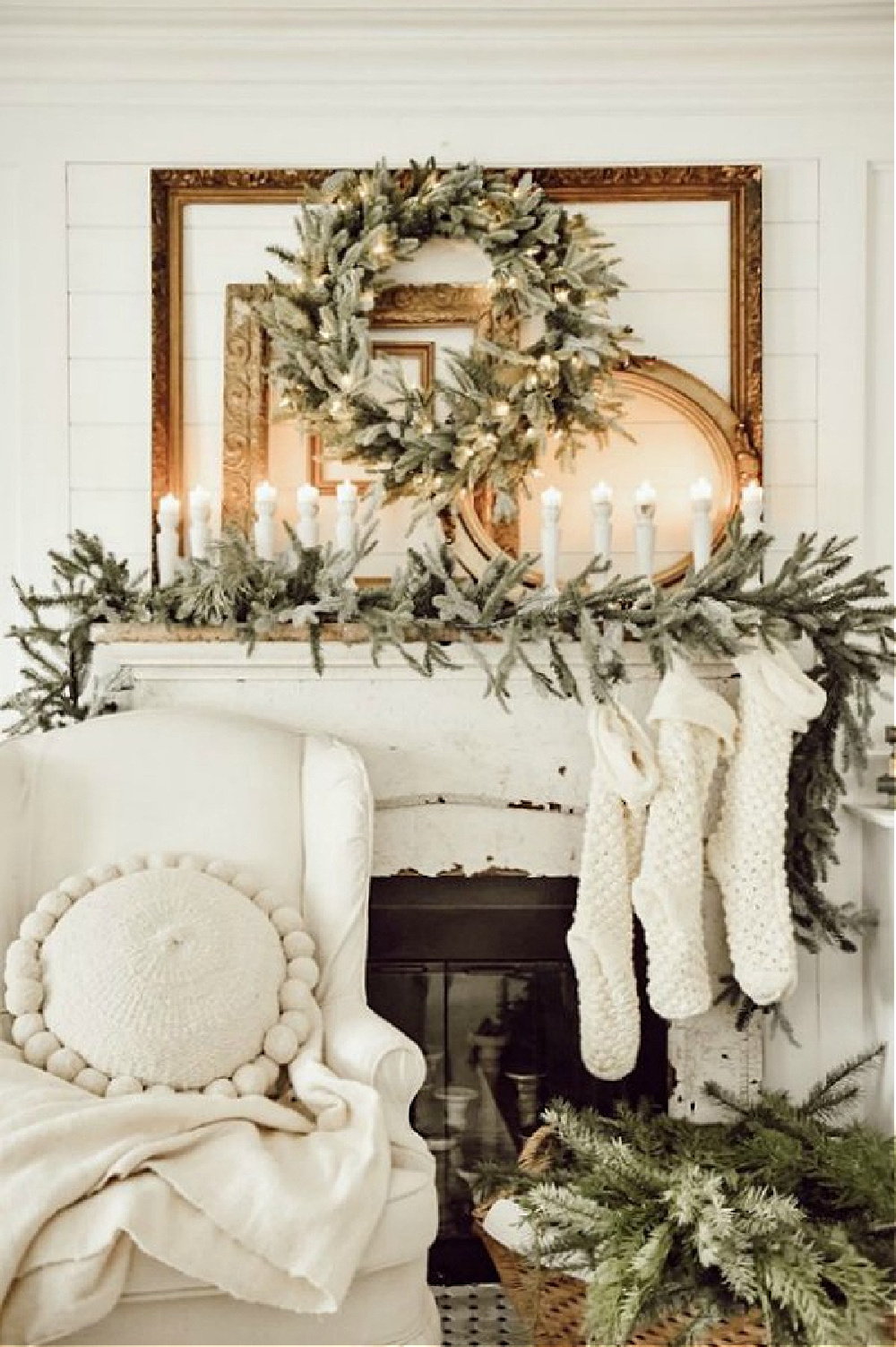 Fraser Firs, Balsam Trees, and Chunky Knit Stockings... are your holiday cozy feels going crazy yet? Liz Marie Blog's stunning farmhouse white Christmas decorated fireplace mantel.