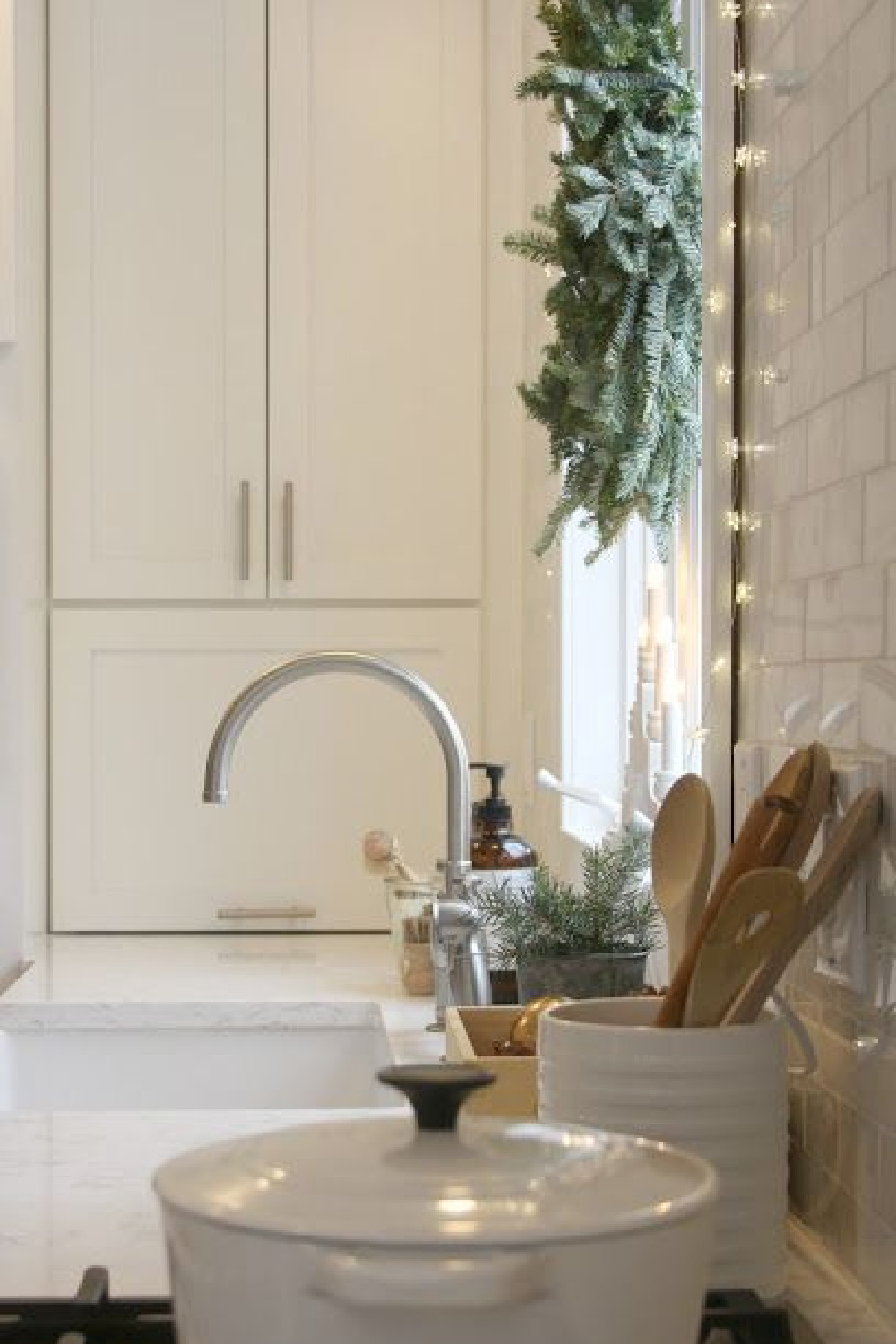 White Christmas decor - in my simple kitchen with fresh fir wreath above farm sink and simple delicate fairy lights. #hellolovelystudio #christmasdecor