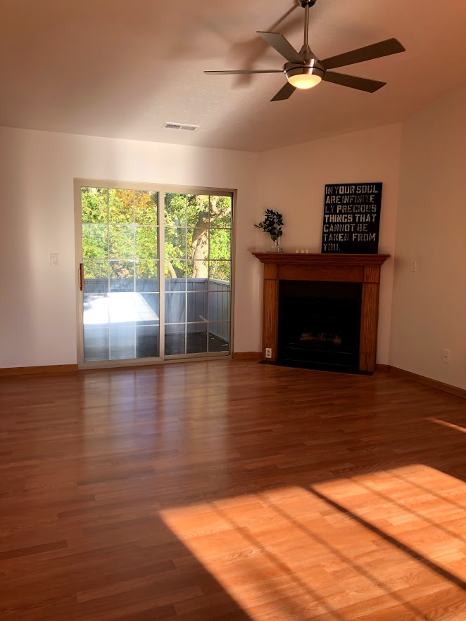 Gladstone Oak laminate flooring replaced the old carpet in the condo's living room with fireplace.