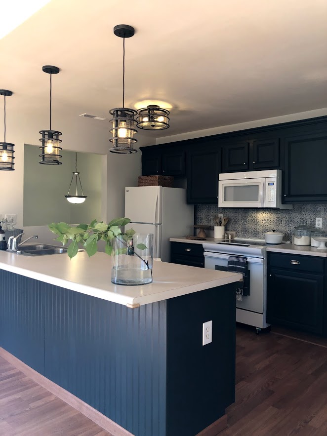 Kitchen cabinets were painted #sherwinwilliamscarbonized in this condo renovation.