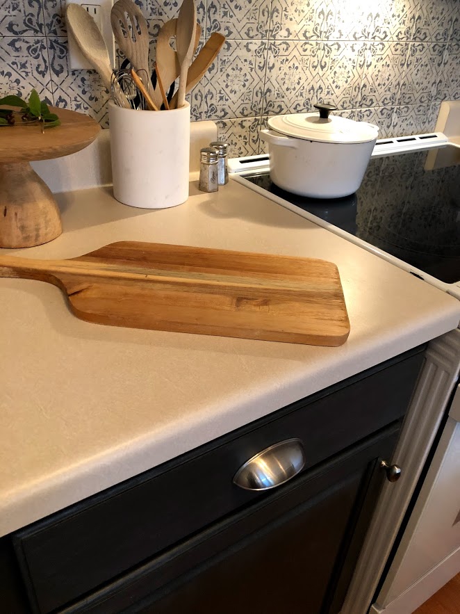 Spanish style backsplash tiles in a kitchen that got a budget conscious renovation.