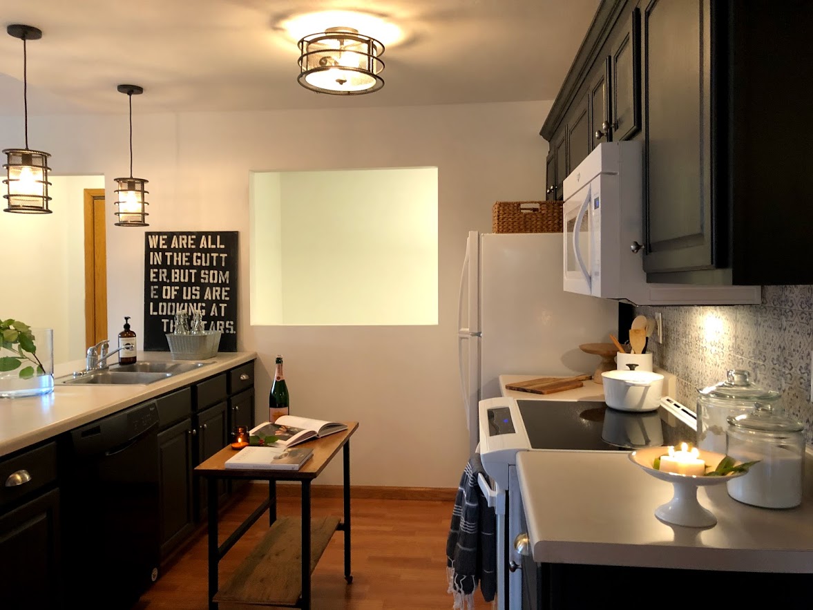 This condo kitchen was greatly improved once we removed an ugly soffit and painted the cabinets Sherwin-Williams Carbonized.