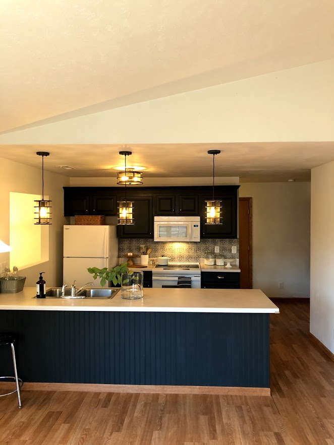 Gladstone Oak laminate flooring from Home Depot was a budget friendly option for this condo's renovation.