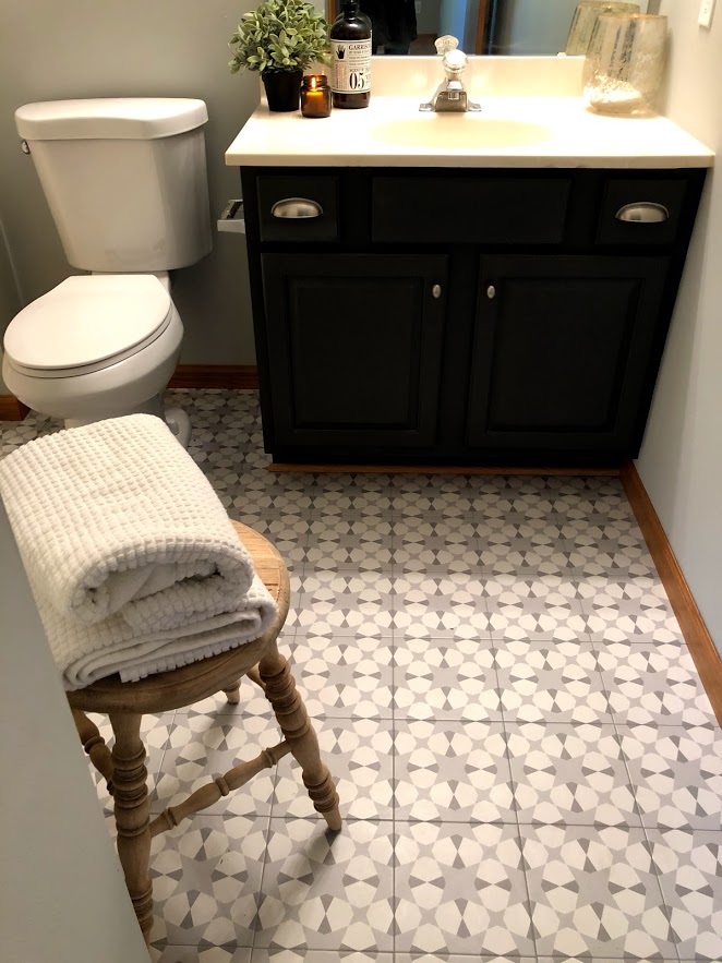 Modern farmhouse style tile in the bathroom only looks like cement - it's an inexpensive porcelain tile that adds personality and charm.