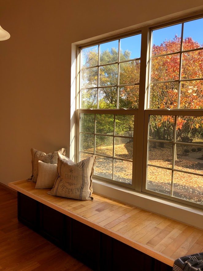 Custom window seat made from salvaged cabinets and salvaged maple hardwood flooring.