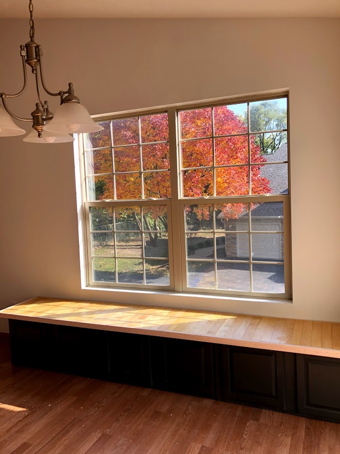 Custom window seat made from salvaged cabinets and salvaged maple hardwood flooring.