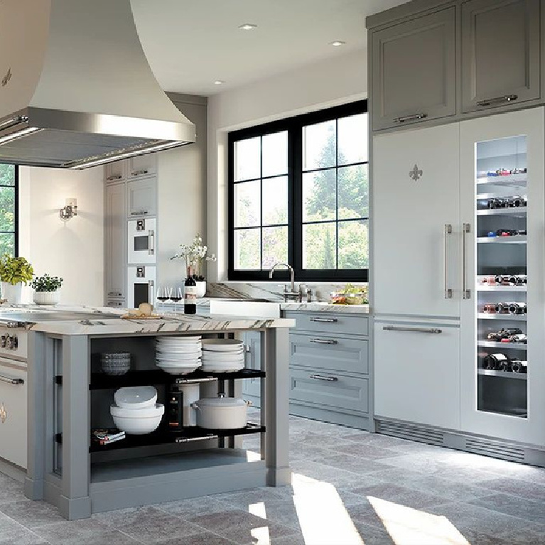 Luxurious bespoke French kitchen by L'Atelier Paris boasts a custom combination refrigerator with glass door. #bespokekitchen #frenchkitchen #customrefrigerator