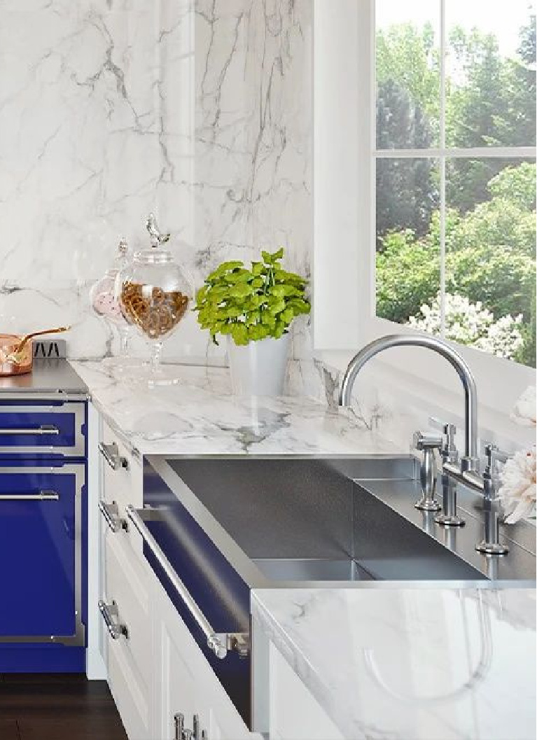 Custom stainless steel apron front sink from L'Atelier Paris is a glorious bespoke option for a luxurious kitchen with white marble and blue French range. #apronfront #kitchensink #bespokekitchen #frenchkitchen