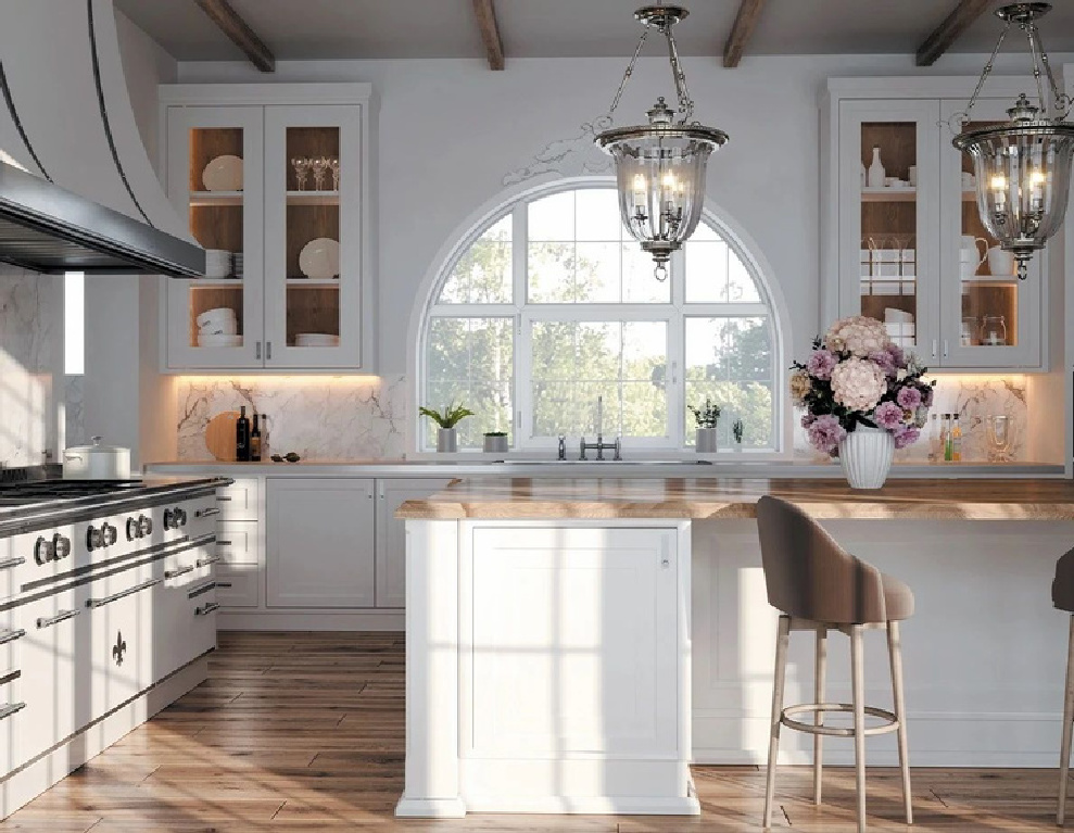 Bespoke French country kitchen with luxurious range and arched window over sink - L'Atelier Paris. #frenchkitchen #frenchcountrykitchen #luxurykitchen #dreamkitchen #bespoke