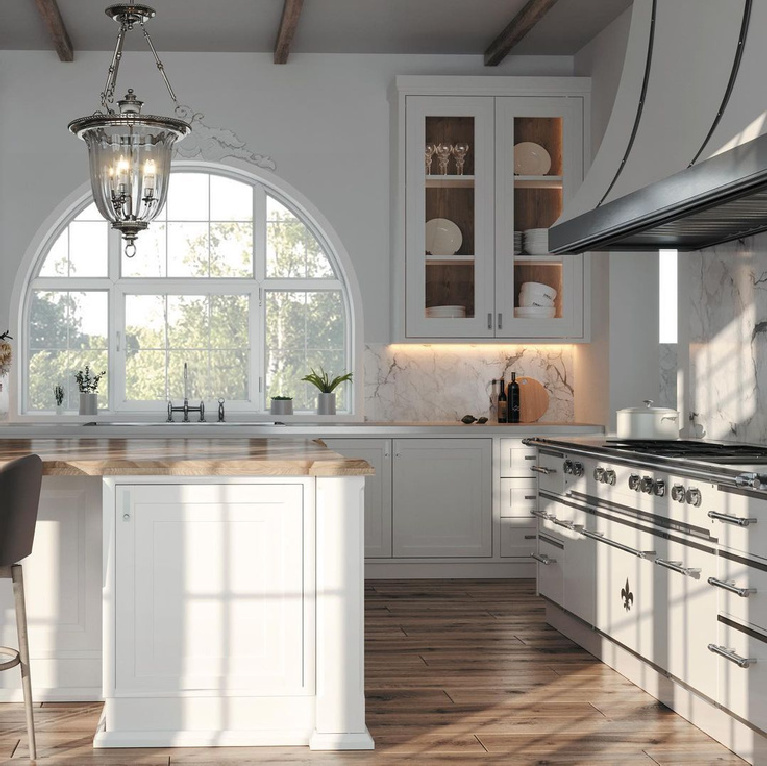 Bespoke French country kitchen with luxurious range and arched window over sink - L'Atelier Paris. #frenchkitchen #frenchcountrykitchen #luxurykitchen #dreamkitchen #bespoke