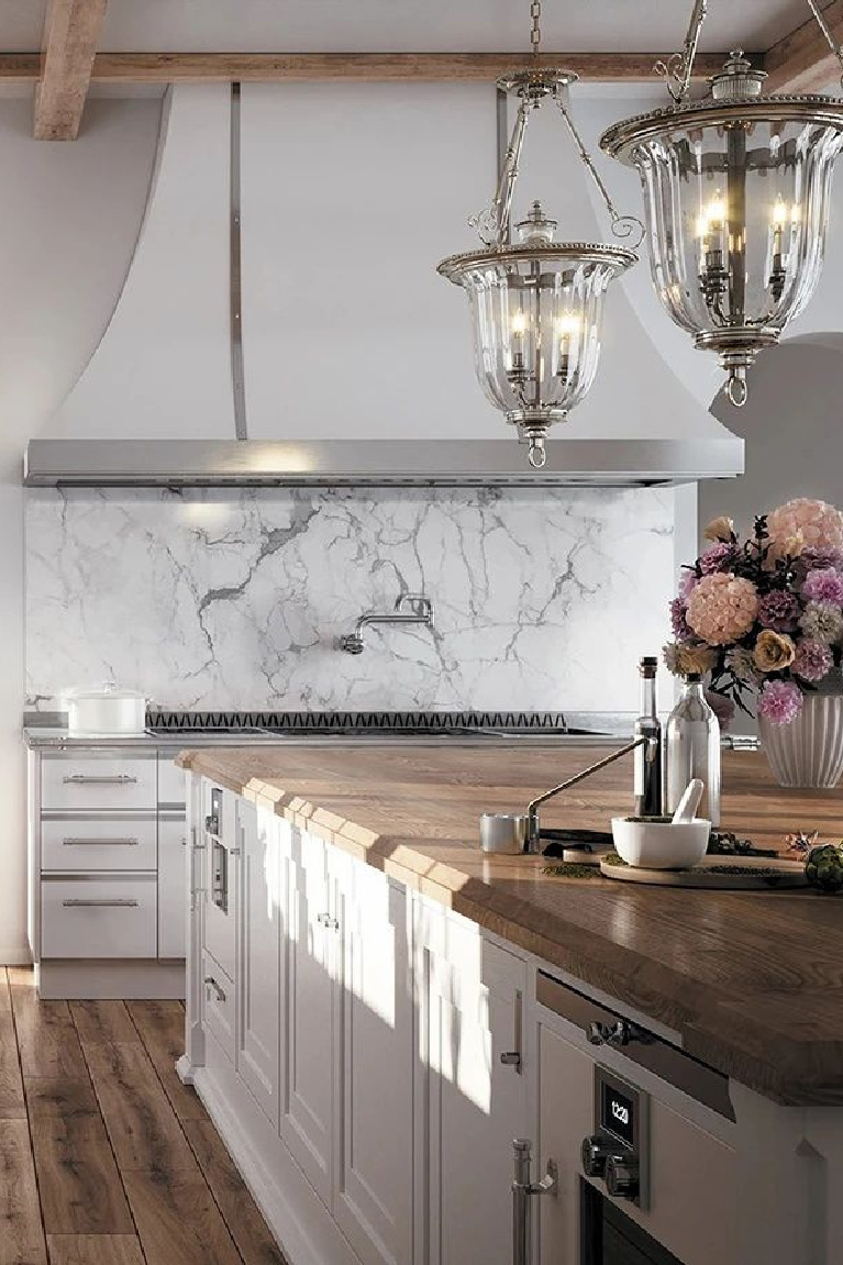 Custom and luxurious white French country kitchen by L'Atelier Paris. #frenchkitchen #customkitchen #luxurykitchen #frenchcountrykitchen