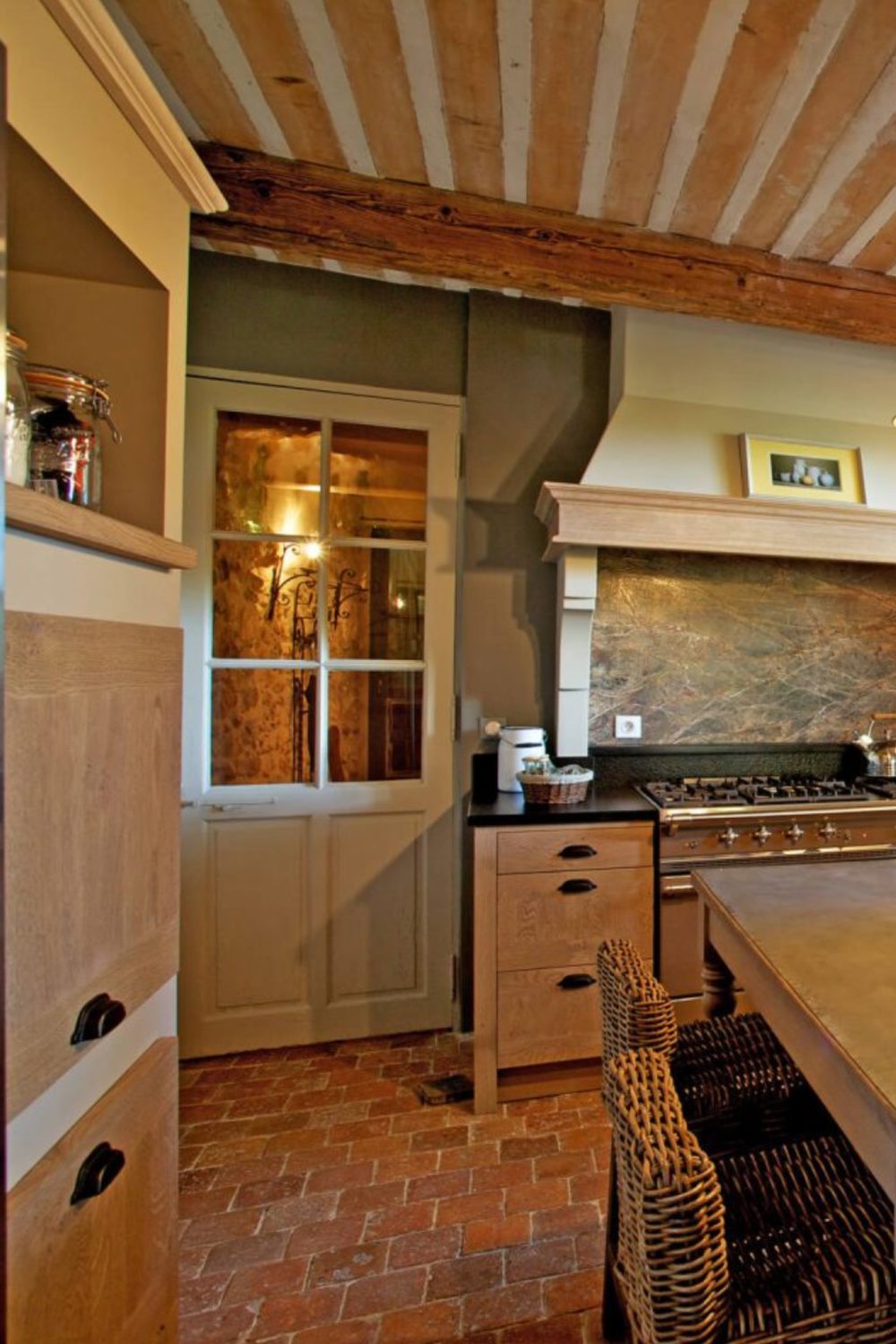 Beautiful French kitchen in Provence with glass door to hall - Haven In. #frenchkitchen #frenchfarmhouse #oldworldkitchen
