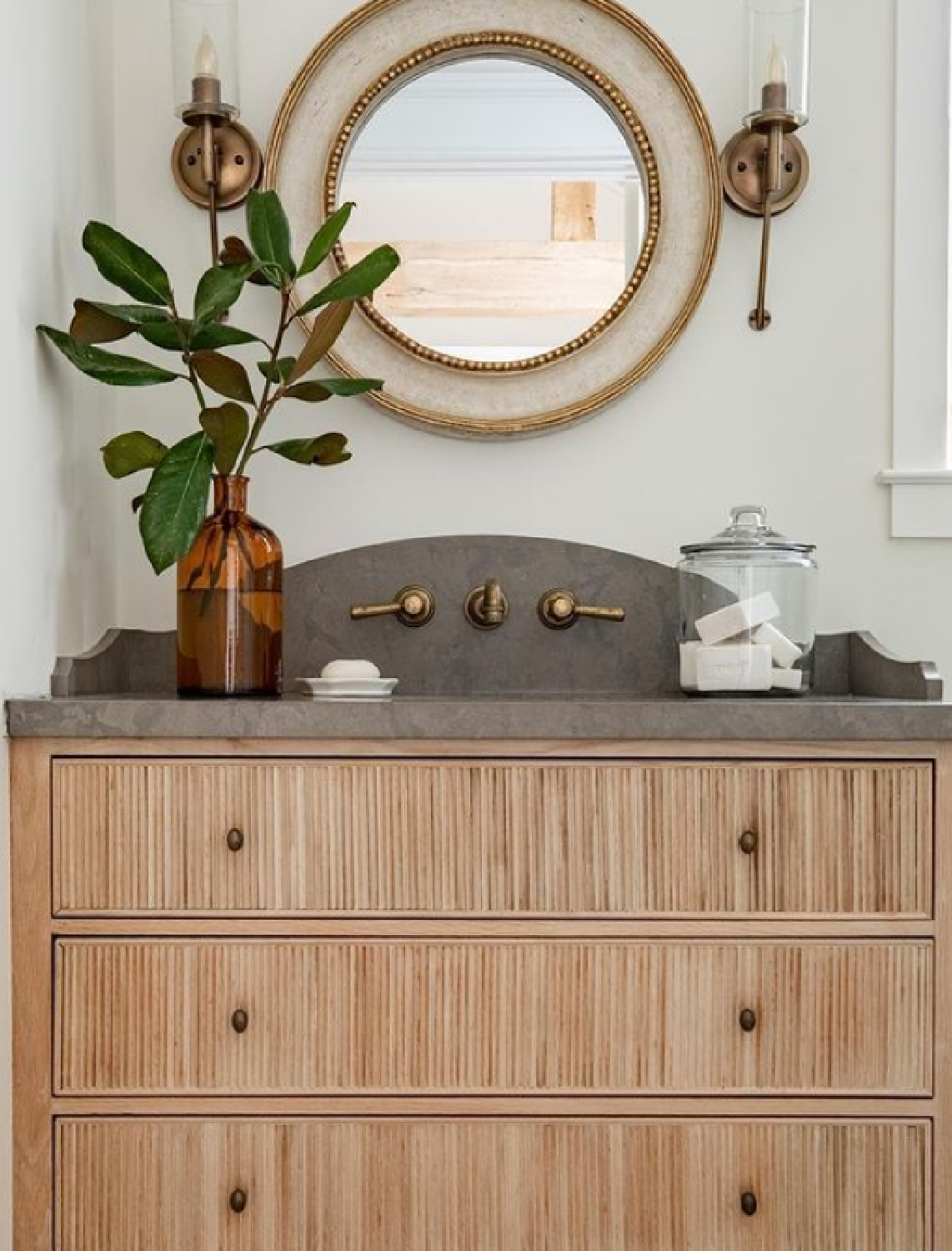 Gorgeous neutral classic luxe bathroom vanity with round mirror and sconces - Marie Fanigan Interiors. #bathroomdesign