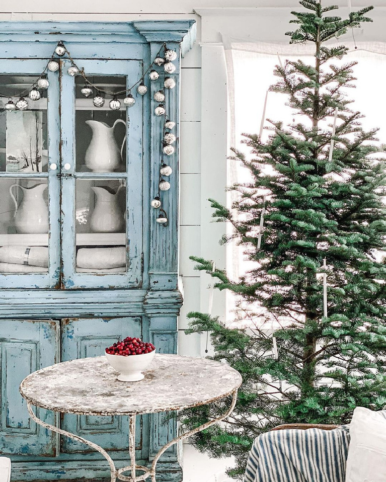 Serene beautiful French farmhouse Christmas decor with old blue cupboard full of ironstone and Christmas tree - DreamyWhites. Enjoy Glorious 2020 Holiday Decorations & Inspiring Quotes for a new year!