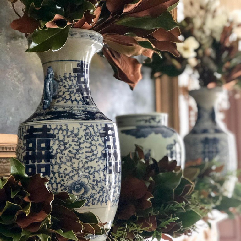 Blue and white porcelain on a mantel decorated for Christmas - @theenchantedhome