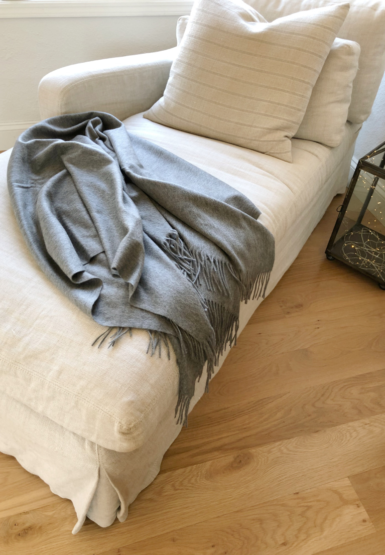 Belgian linen upholstered chaise (RH) with a heather gray cashmere throw (Italic) in my living room - Hello Lovely Studio.