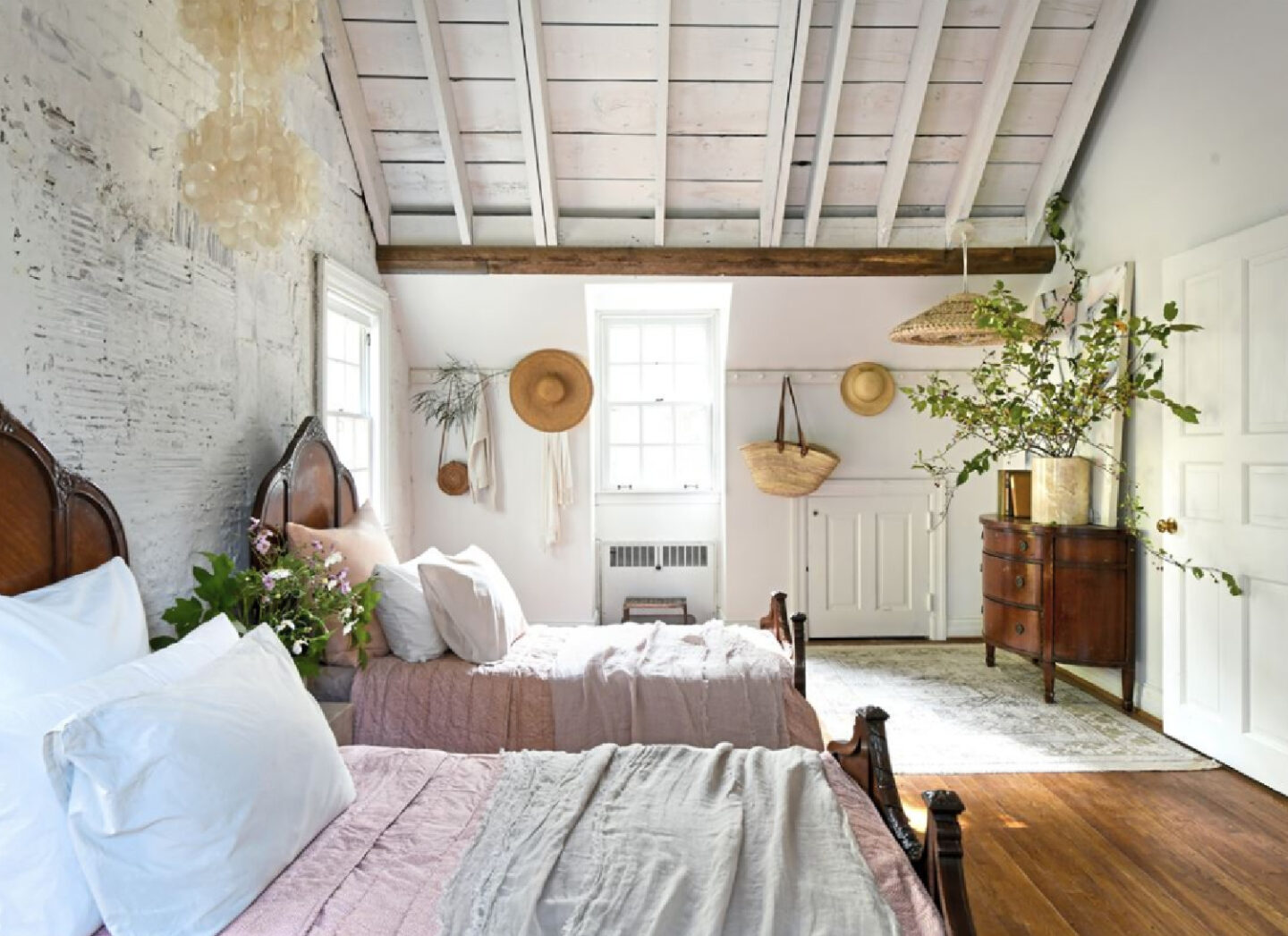 Leanne Ford designed rough luxe bedroom with exposed rafters painted white in her Pittsburgh guest cottage - photo by Erin Kelly for Pittsburgh Post Gazette. #modernrustic #vintagestyle