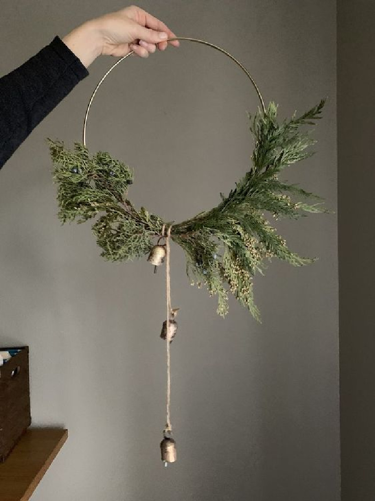 Modern Scandi hoop wreath for Christmas decor with a Swedish feel - natural greenery and sweet gold bells - Allisa Jacobs.