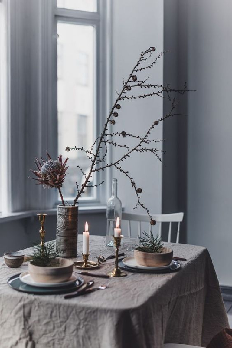 Pale Swedish Christmas tablescape with wrinkly tablecloth and rustic organic touches for a simple Scandinavian style holiday - Gunn Kristin Monsen.