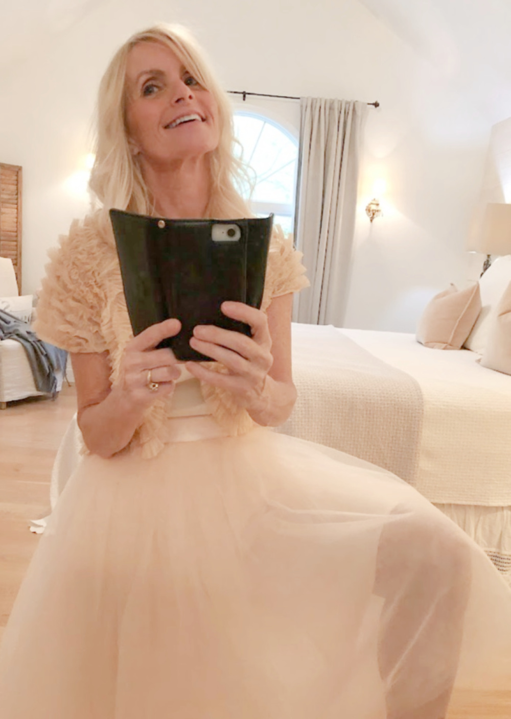 Michele of Hello Lovely in pale pink tutu in serene bedroom.