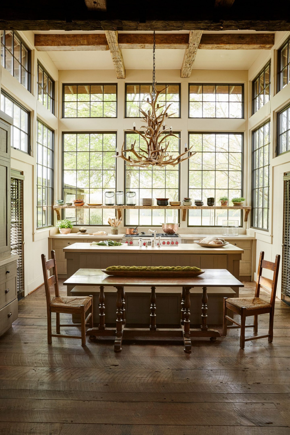 Magnificent walls of windows in a breathtaking rustic luxe kitchen designed by architect Jeffrey Dungan!