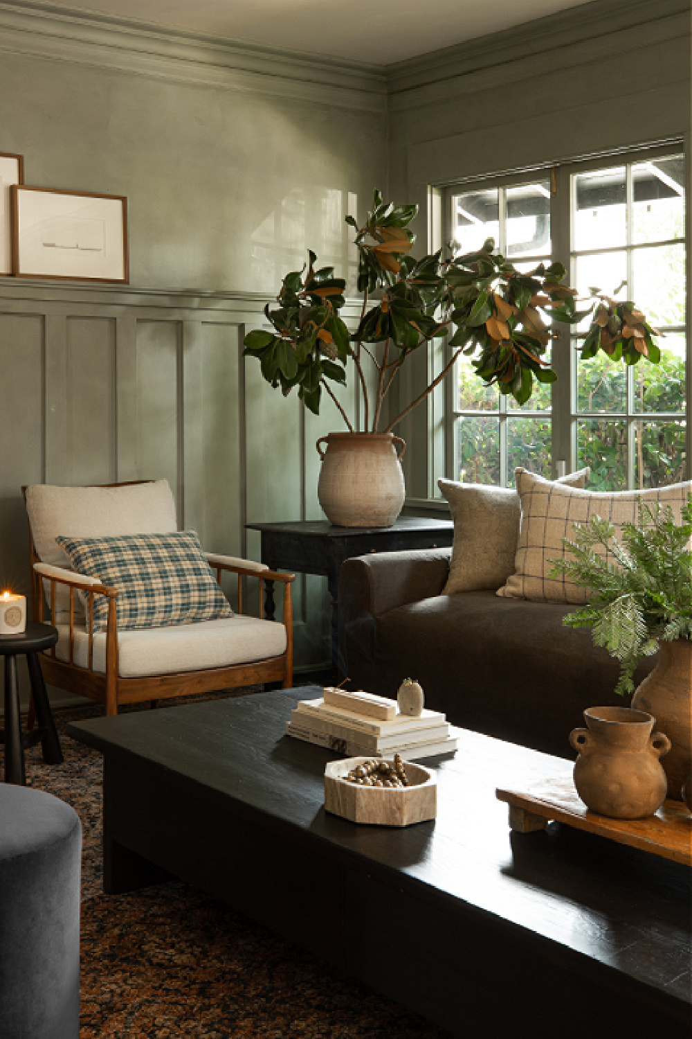 Earthy green millwork in a cozy modern rustic living room by Amber Lewis. #interiordesign #earthygreen #livingrooms