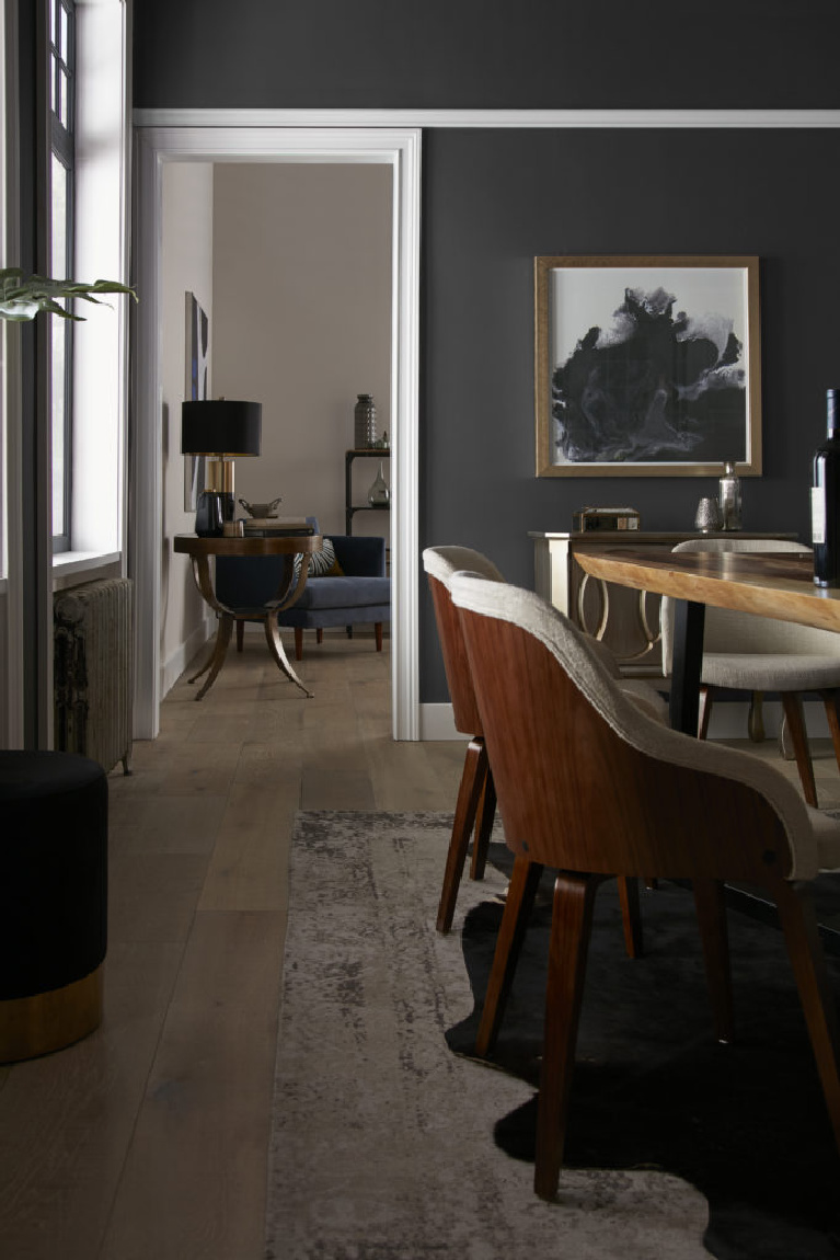 Behr Broadway paint color in a dining room is a deep dark bronzy soft black-brown for a bit of drama for your walls. Discover inspiring understated neutrals to try in your own home. #behrbroadway #paintcolors #blackpaints