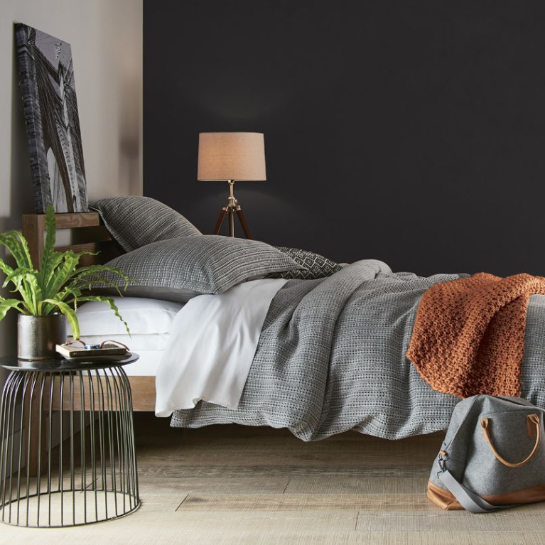 Behr Broadway paint color in a bedroom is a deep dark bronzy soft black-brown for a bit of drama for your walls. Discover inspiring understated neutrals to try in your own home. #behrbroadway #paintcolors #blackpaints