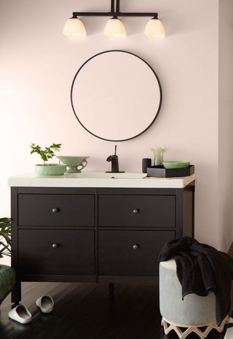 Behr Seaside Villa warm pink paint color in a bathroom with black vanity. Discover inspiring understated neutrals to try in your own home. #behrseasidevilla #paintcolors