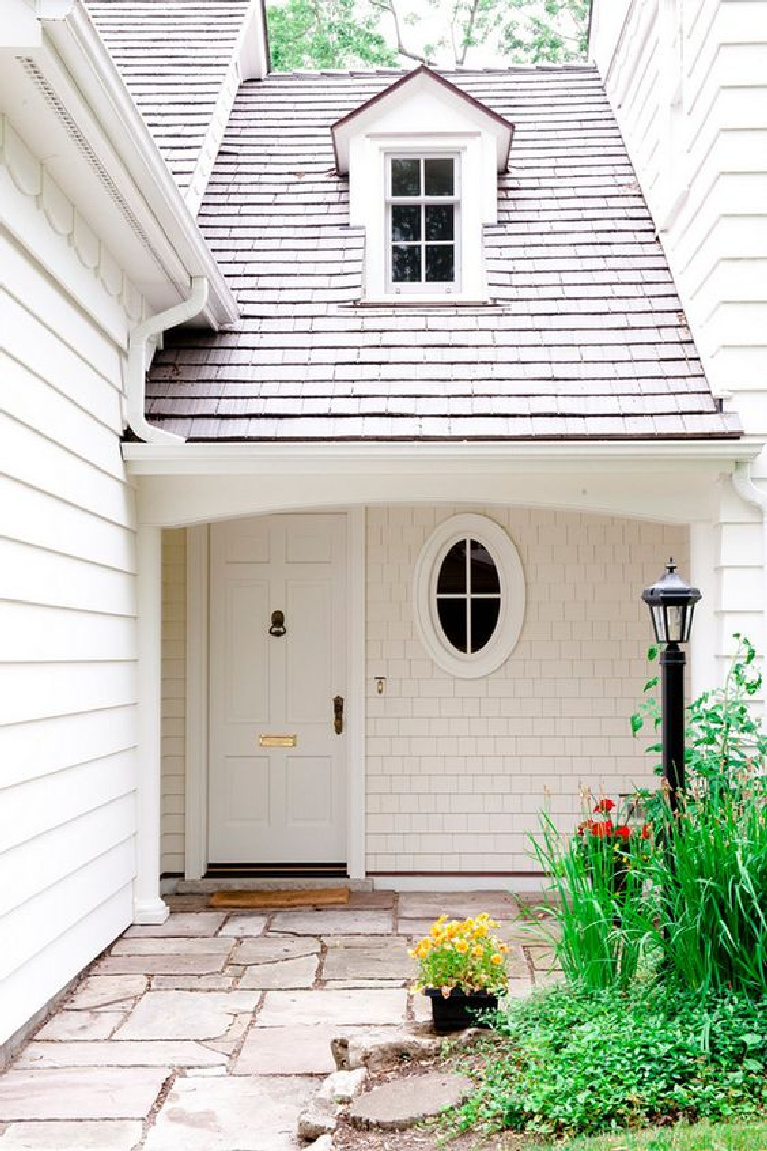 Front door painted Atrium White (Benjamin Moore) for this gorgeous classic traditional home exterior. Discover inspiring understated neutrals to try in your own home. #atriumwhite #paintcolors #frontdoor #benjaminmooreatriumwhite #paintcolors