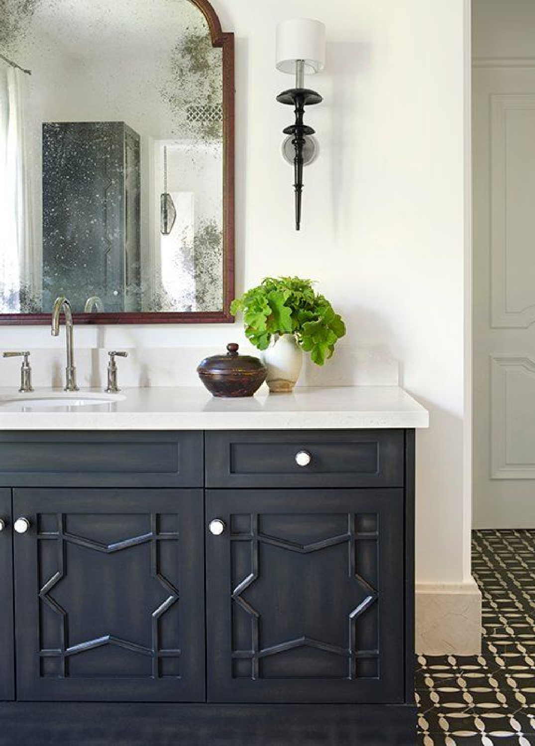 Beautiful black vanity in a bathroom designed by Betsy Burnham. Come check out Antique Vintage Style Bathroom Vanity Inspiration! #bathroomdesign #bathroomvanity #classicstyle #traditionaldecor #interiordesignideas