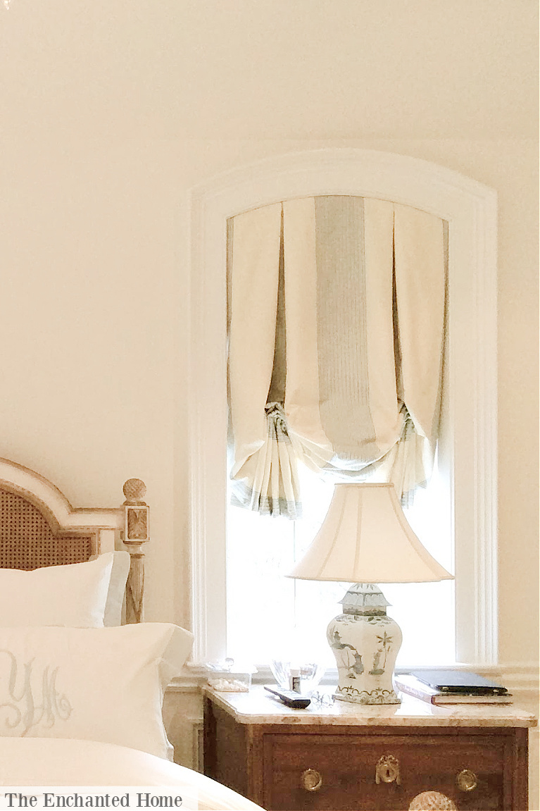 Traditional style balloon style valance and bedside lamp in a pretty bedroom reflecting Grandmillennial style - The Enchanted Home. #grandmillennialstyle #bedroom #interiordesign