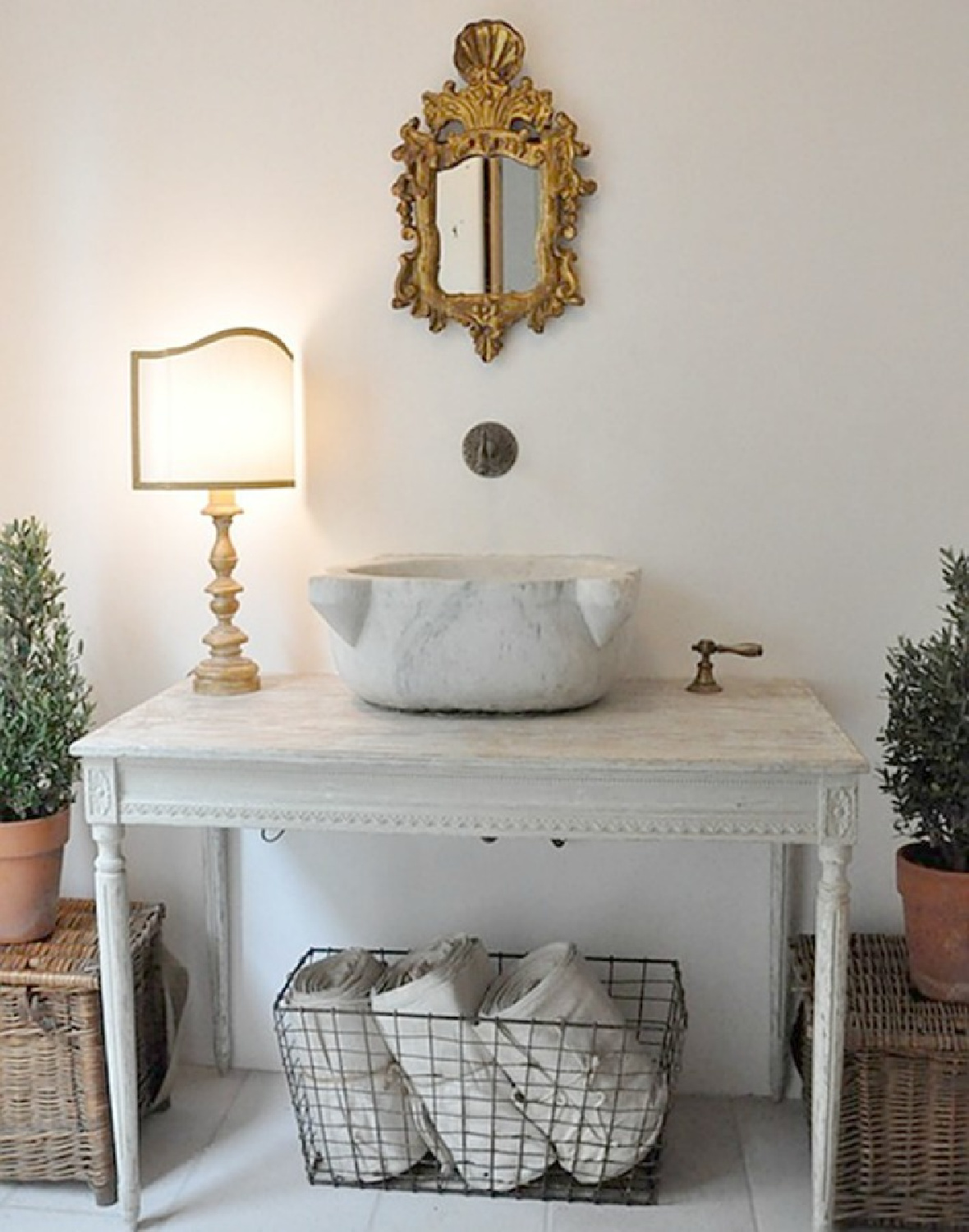 When a rustic French farmhouse powder room with repurposed antique table and vessel sink is this gorgeous, who would want to leave? Design by Brooke Giannetti. #europeancountry #oldworld #bathroom