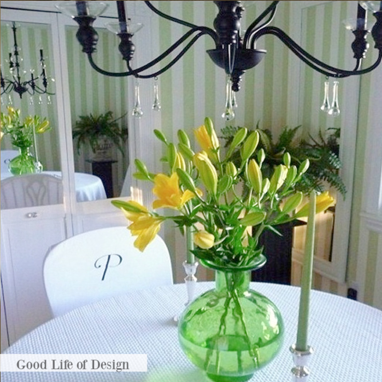 Cheerful green stripe wallpaper and accents in a dining room with Grandmillennial traditional decor style - Good Life of Design.