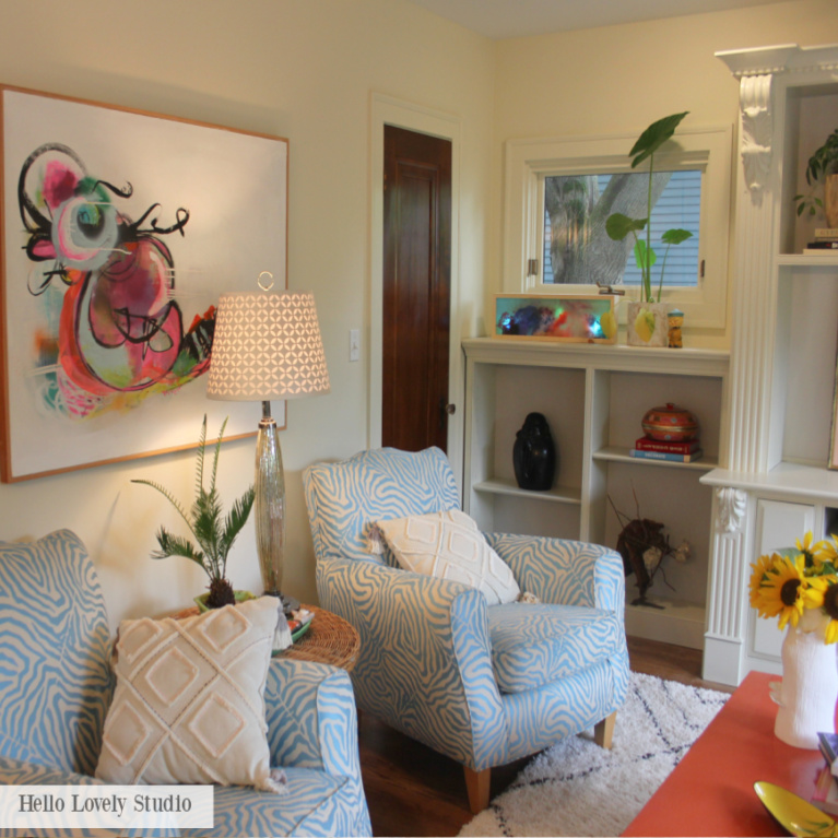 Colorful den with vintage chairs and a mix of patterns reflects Grandmillennial style - Jenny Sweeney designed space on Hello Lovely.