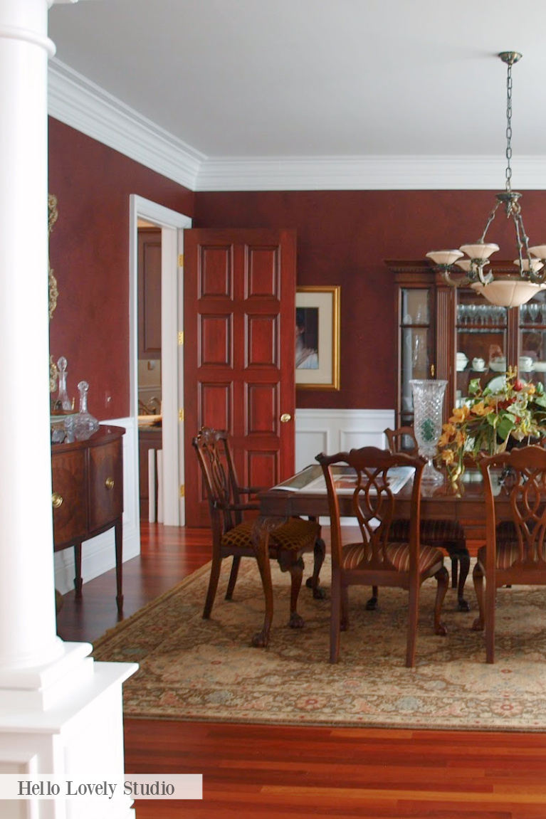 Deep reds and browns in a traditional style dining room with Grandmillennial charm - Hello Lovely.