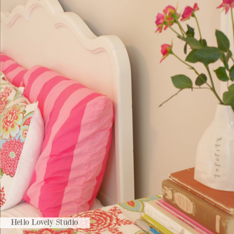 Bright pink stripes and florals in a vintage style bedroom with Grandmillennial style - Hello Lovely.