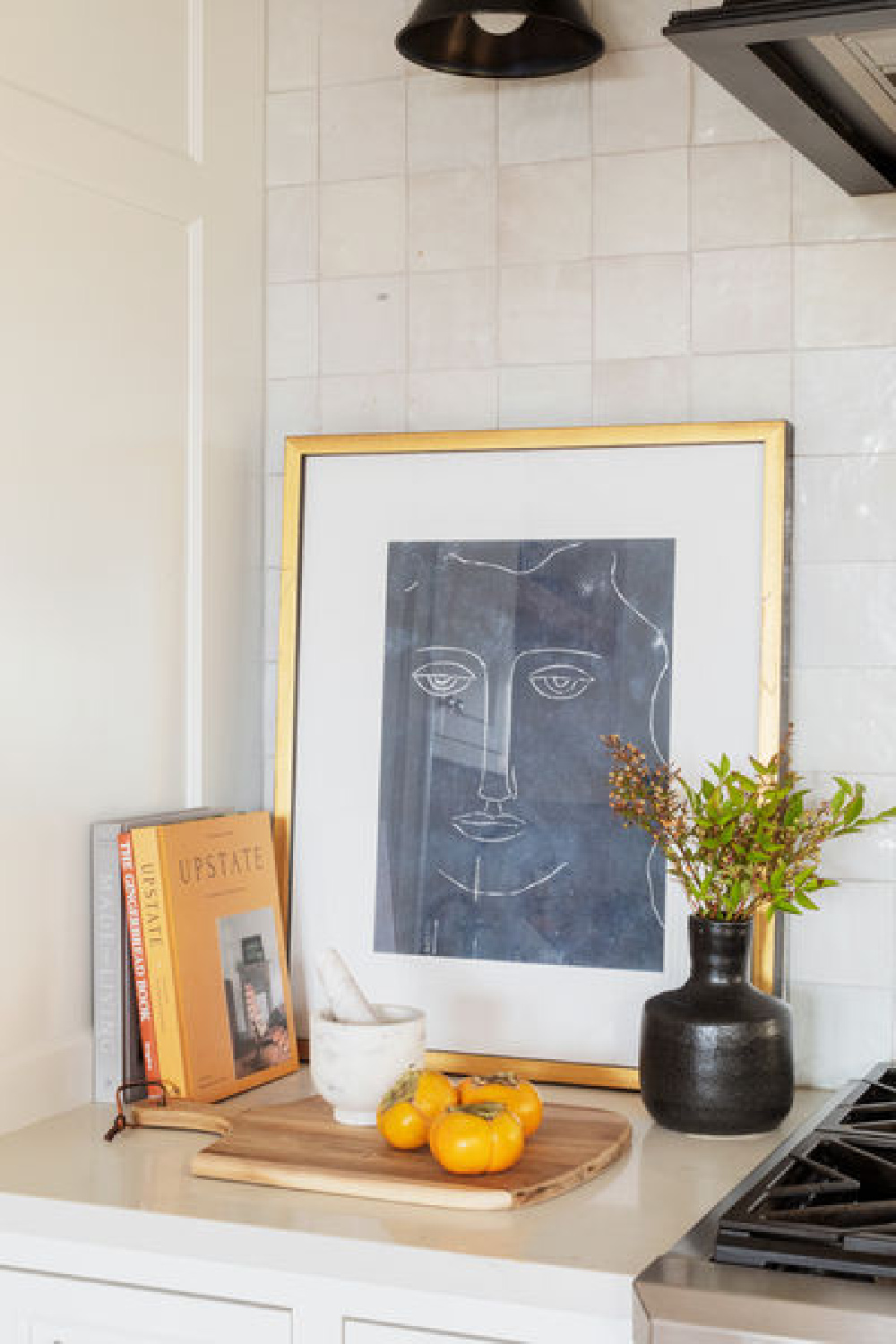 Neutral kitchen vignette with black and white and Zellige tile backsplash - Scout & Nimble.