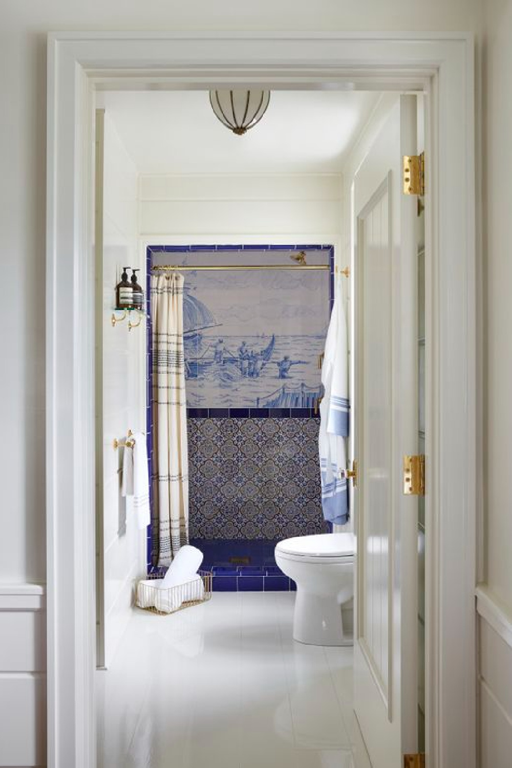 Greydon House bathroom with cobalt blue shower tile. COME TOUR MORE Nantucket Style Chic & Summer Vibes! #nantucket #interiordesign #designinspiration #summerliving #coastalstyle