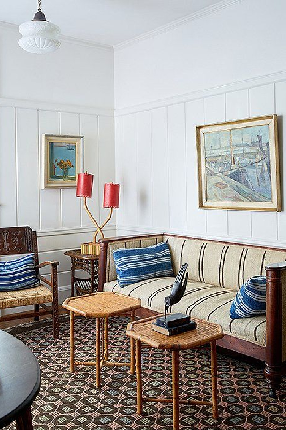 A seating area in one of the suites features an eclectic collection of antiques, including an English sofa, bamboo pieces from the South Pacific, and Nordic paintings.