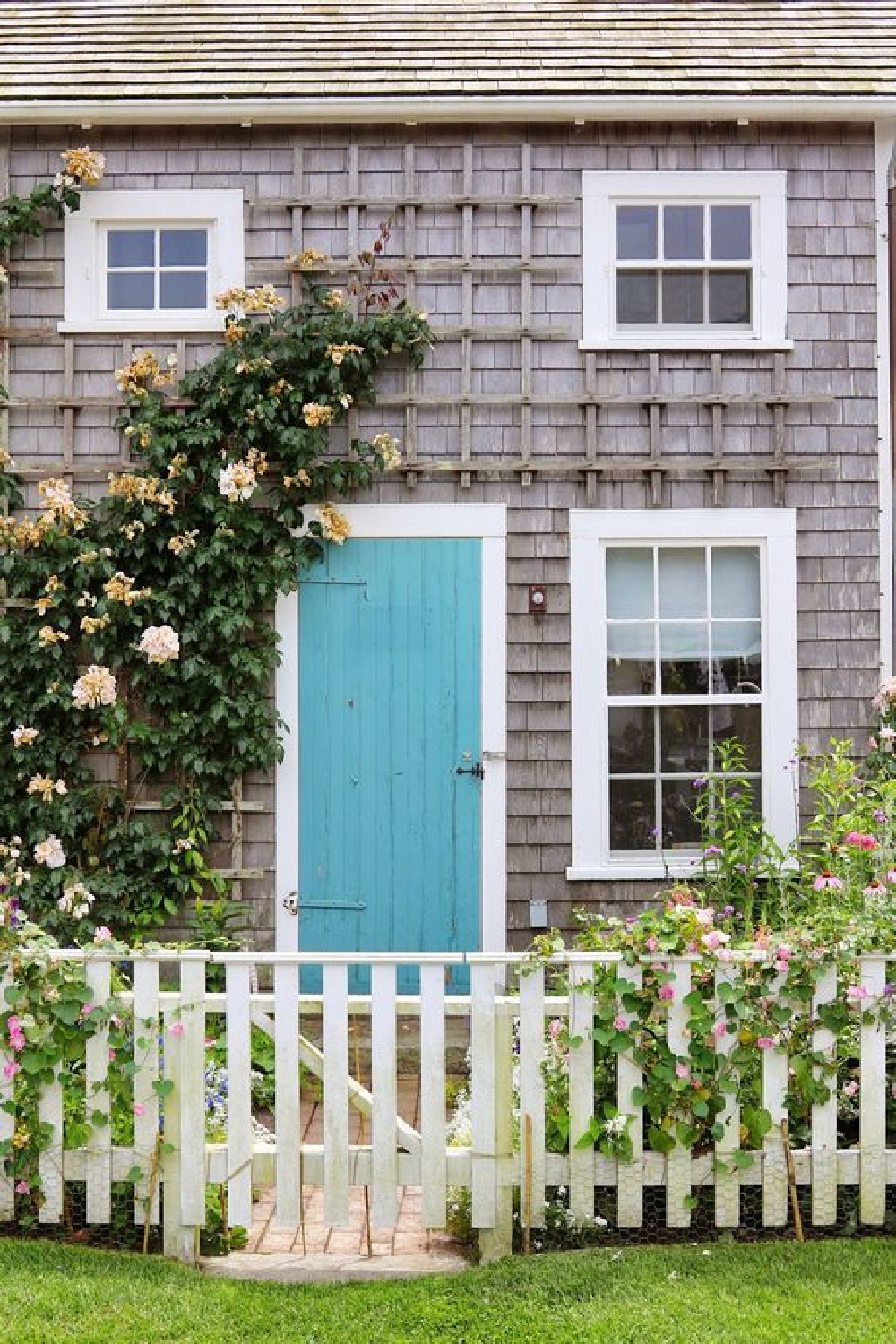 Nantucket cottage exterior with bright blue door. Sconset in Bloom. COME TOUR MORE Nantucket Style Chic & Summer Vibes! #nantucket #interiordesign #designinspiration #summerliving #coastalstyle