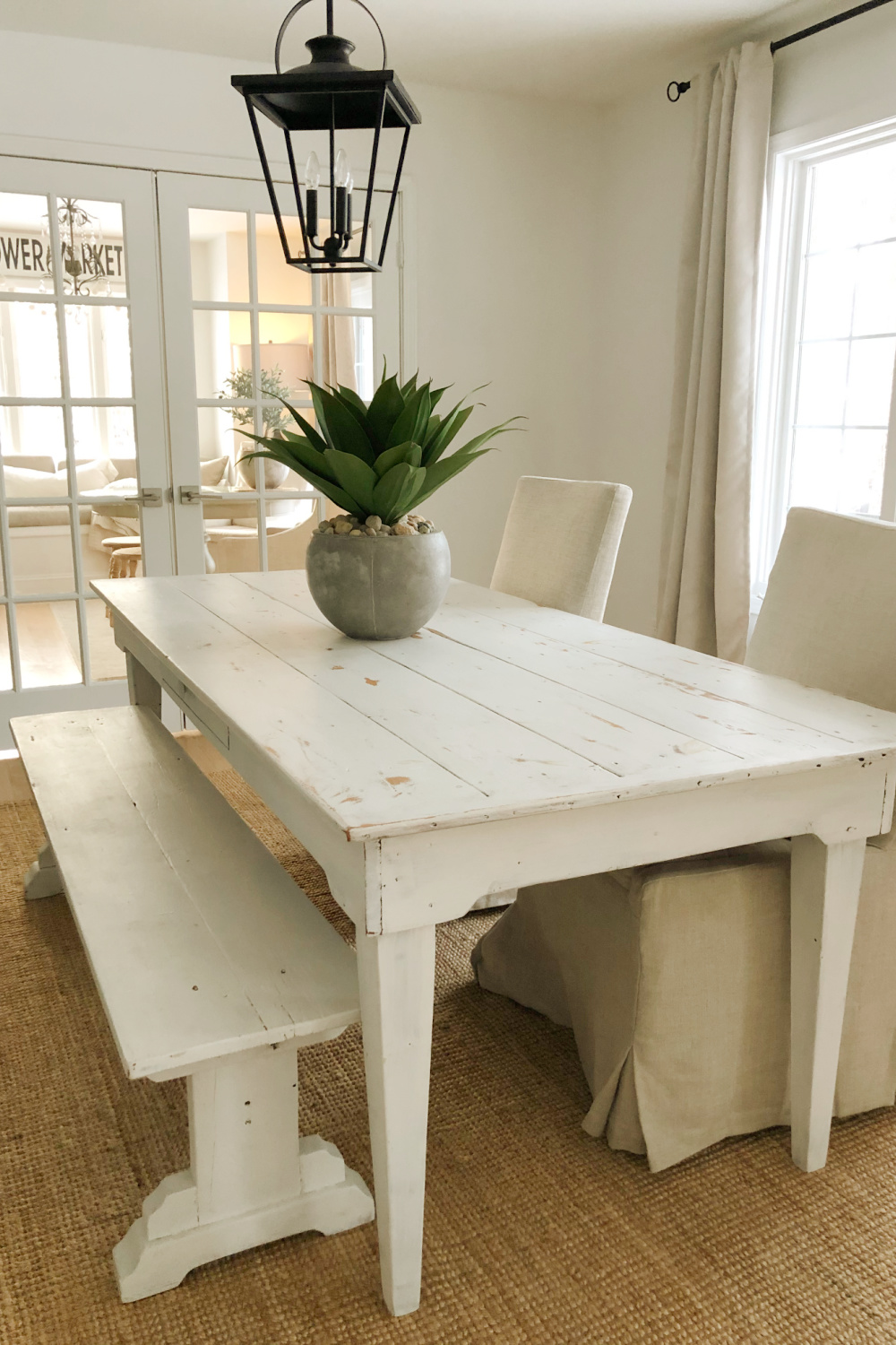 Simple spare and natural dining room with farm table and 24" artificial agave potted succulent- Hello Lovely Studio.